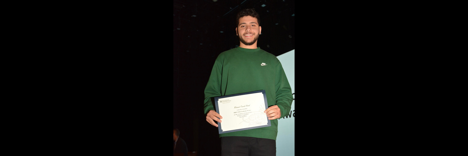 A picture of a student with their certificate of excellence 