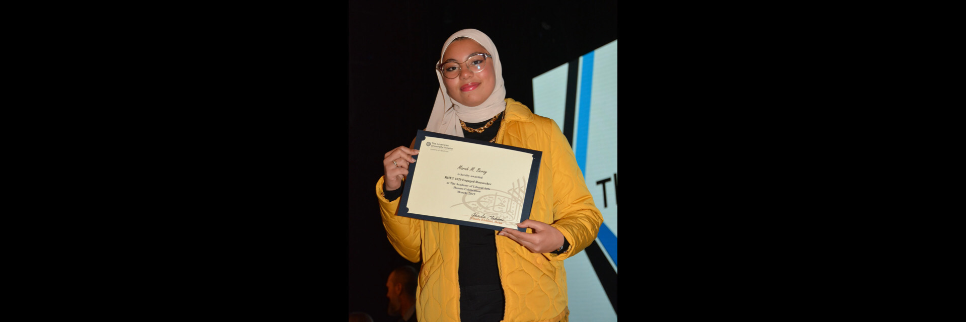 A picture of a student with their certificate of excellence 
