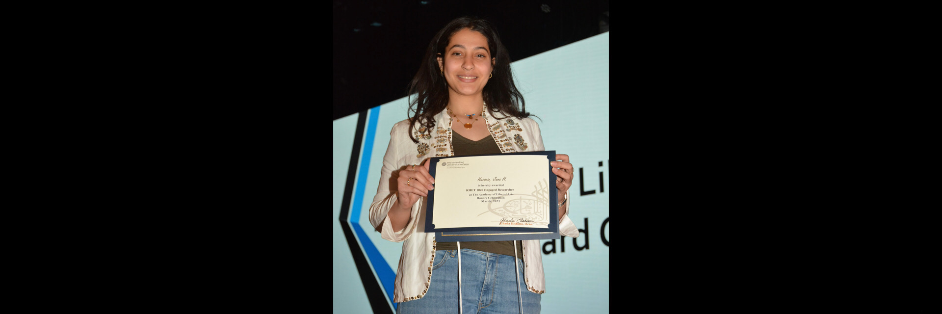 A picture of a student with their certificate of excellence 