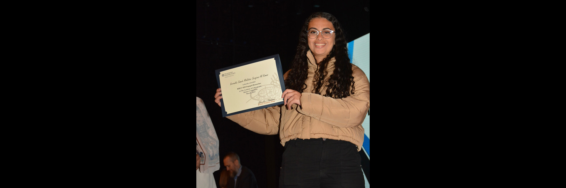 A picture of a student with their certificate of excellence 
