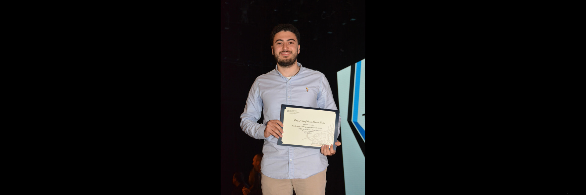 A picture of a student with their certificate of excellence 