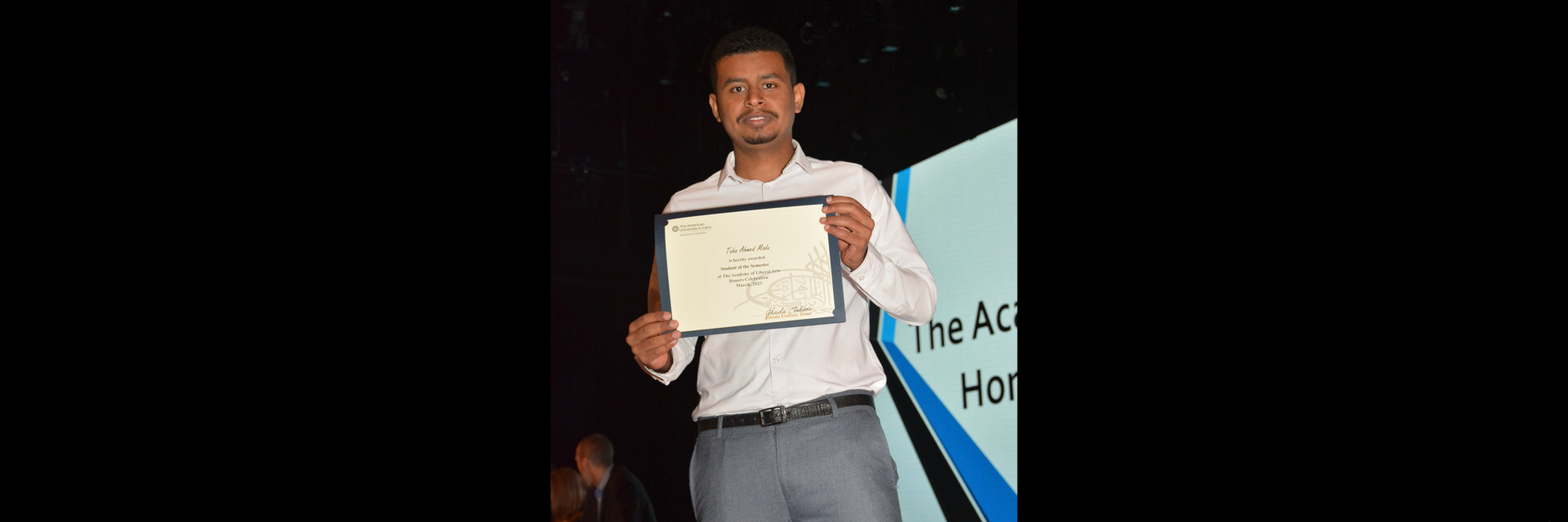 A picture of a student with their certificate of excellence 