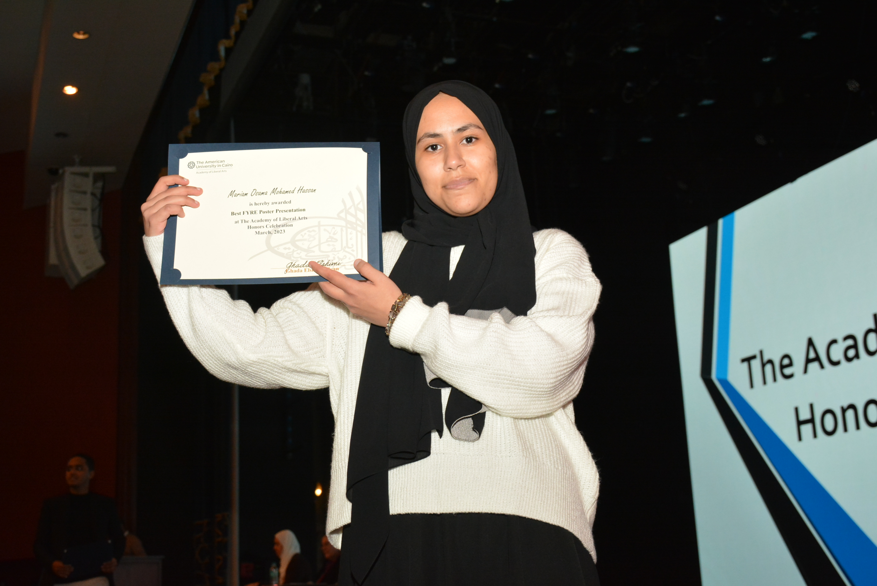 A picture of a student with their certificate of excellence 