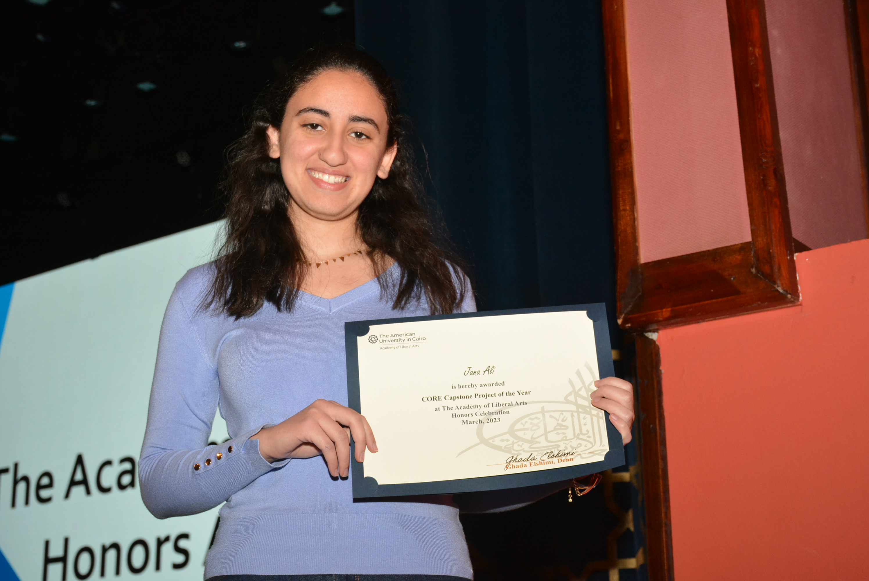 A picture of a student with their certificate of excellence 