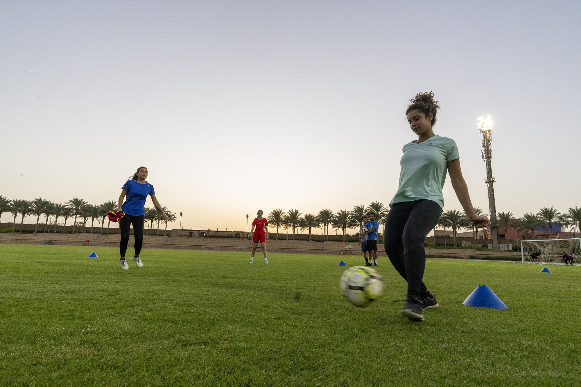 Two girls playing football on a football field