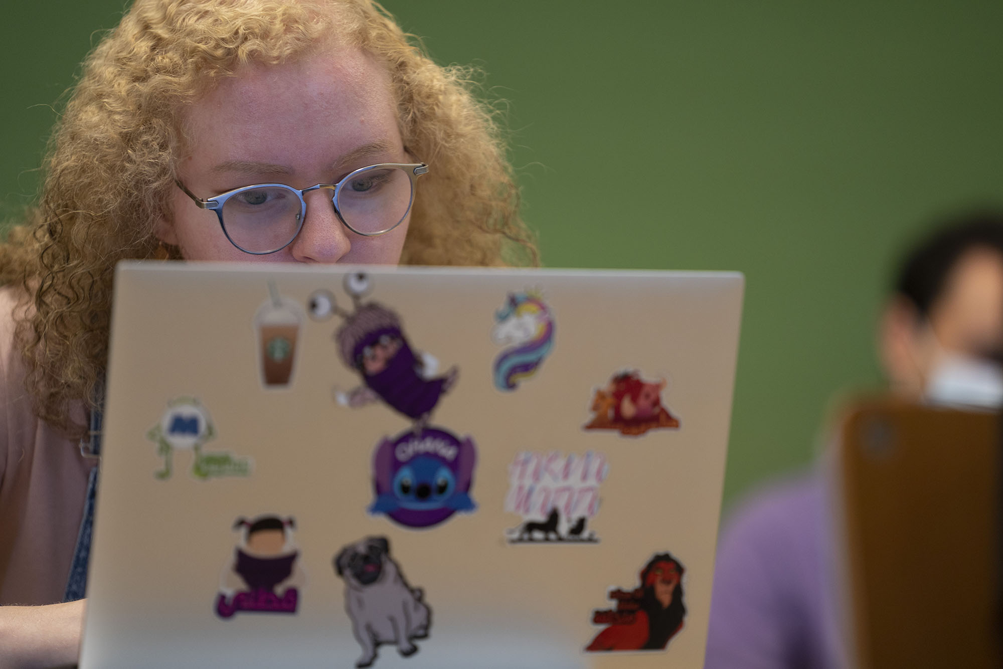 Blonde girl in class with her laptop 