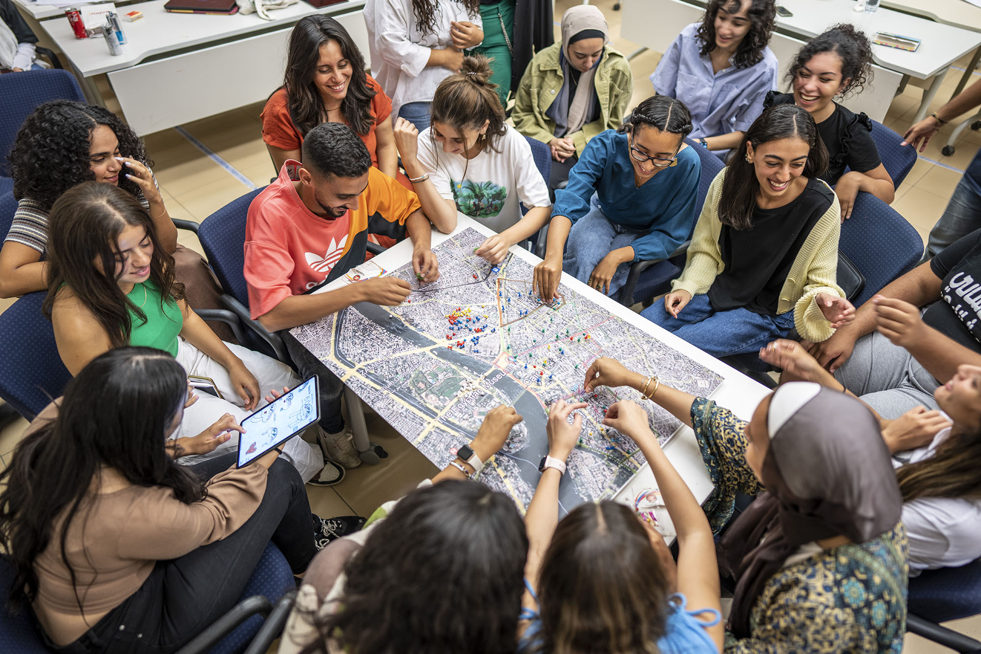 Students sitting around a map and discussing it together 