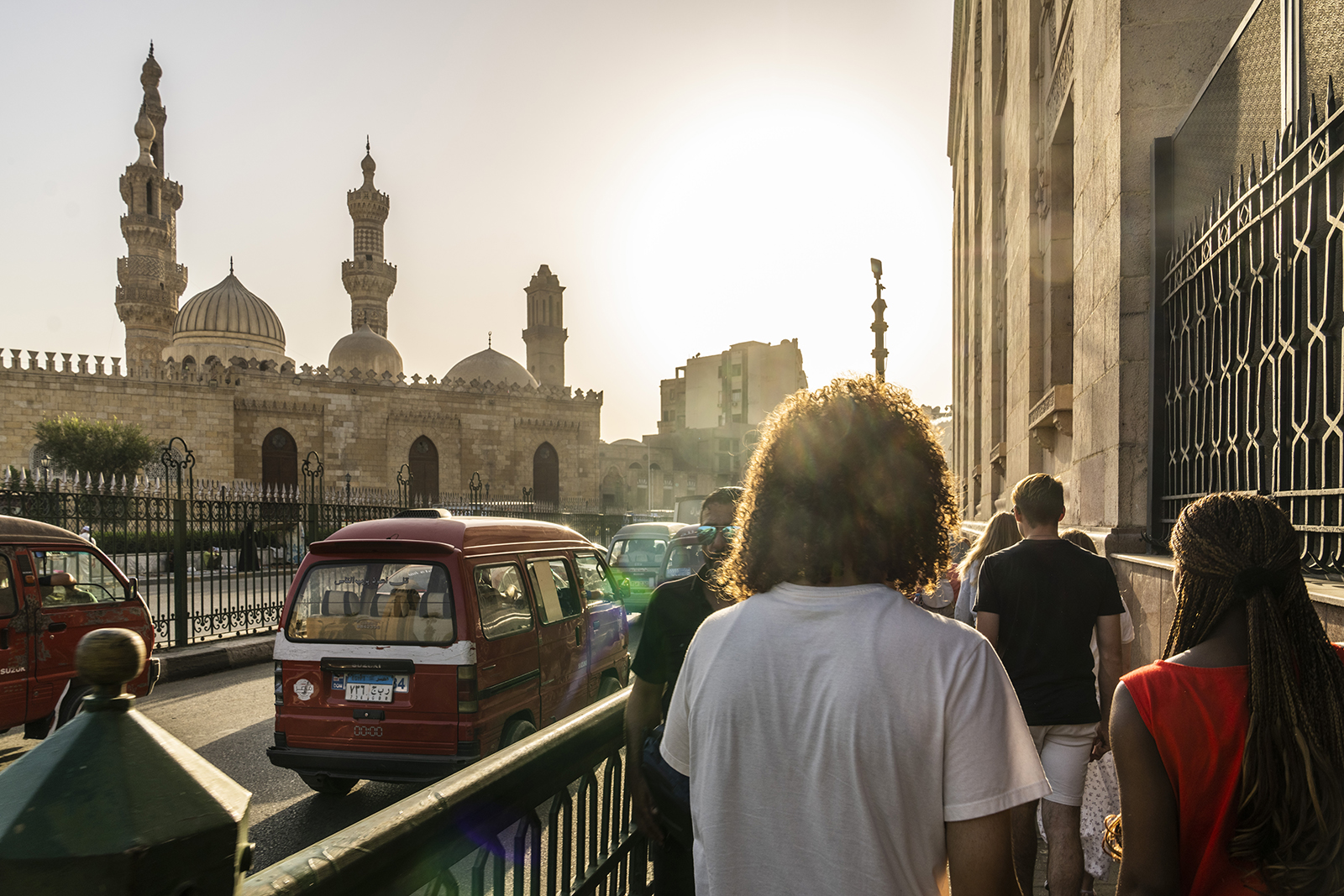 Students walking in streets of Cairo beside a mosque