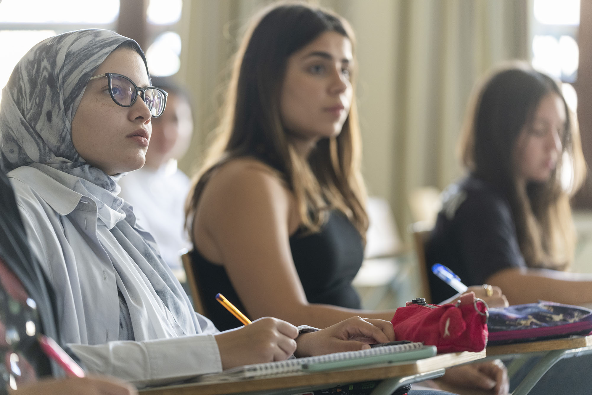 students attending class and writing notes