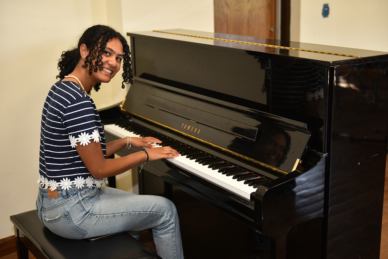 Girl sitting on a piano