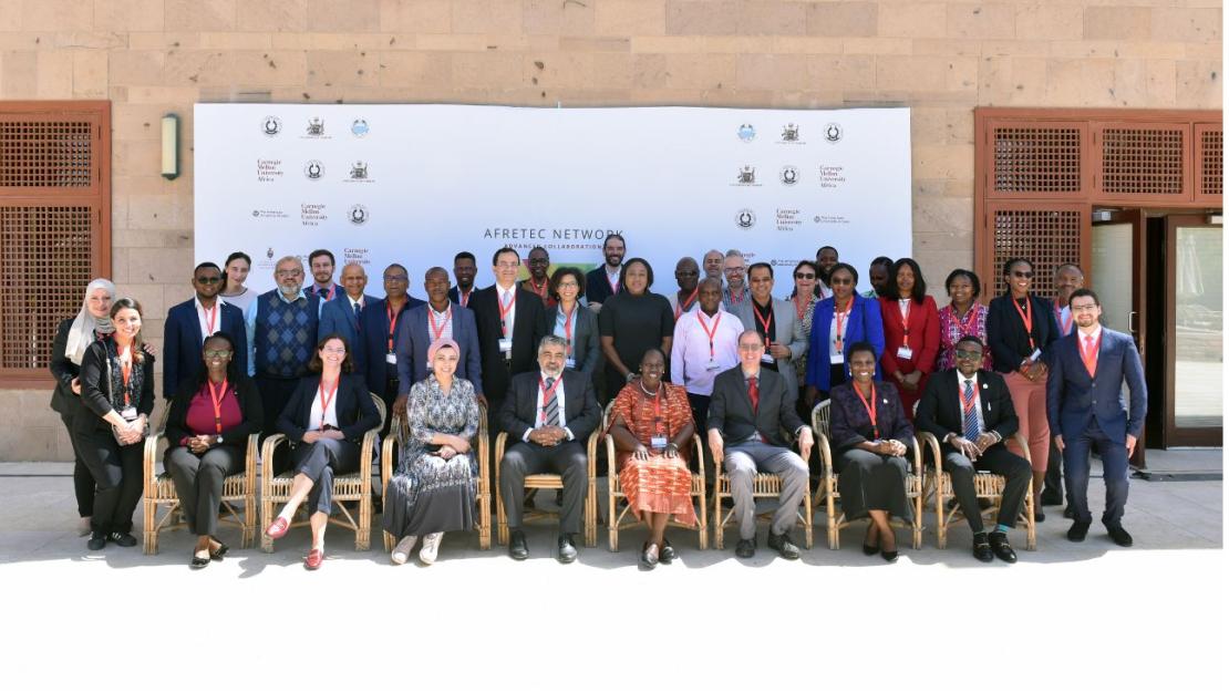 The attendees of the conference pose in a group shot on campus.