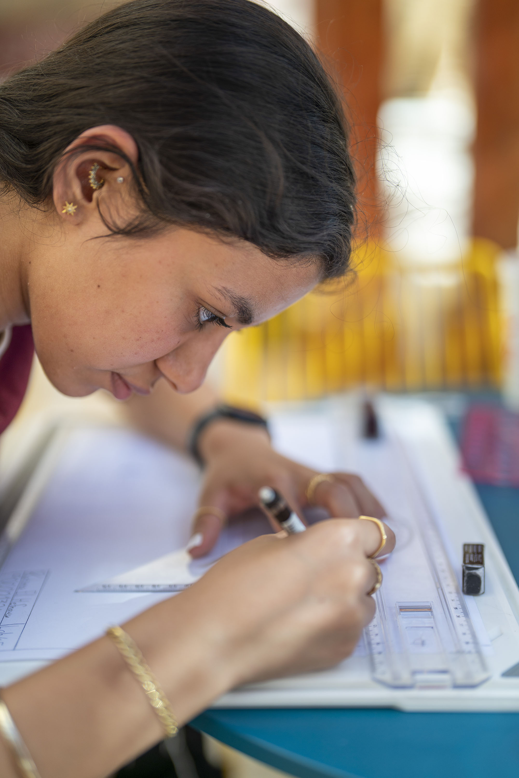 student working on drawing board with architecture equipment