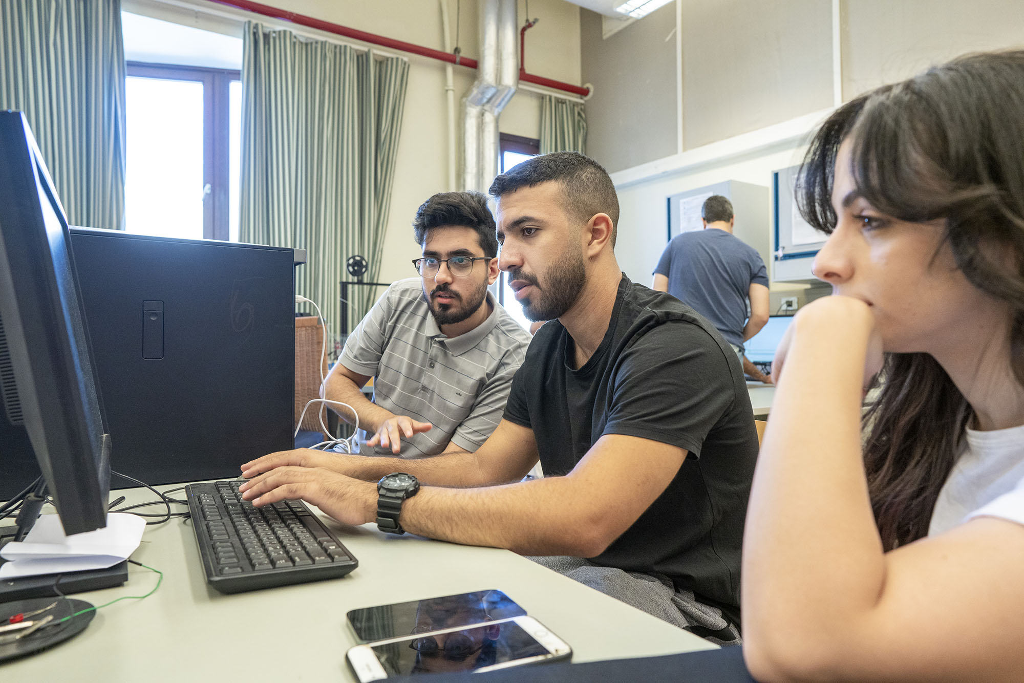 computer program image of group students working on a group project on a computer