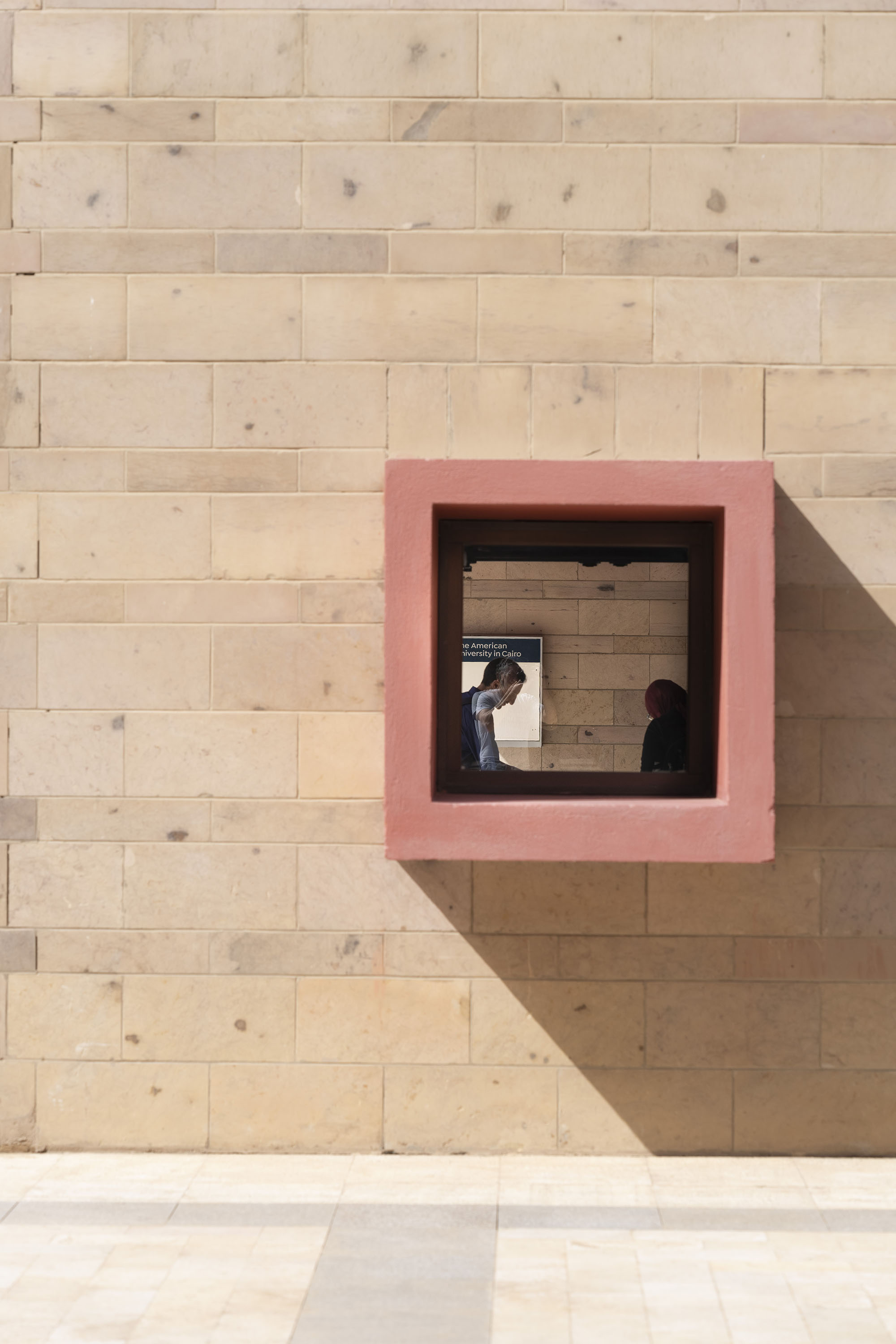 counseling psychology program image of wall with focus of student inside an open frame inside the wall