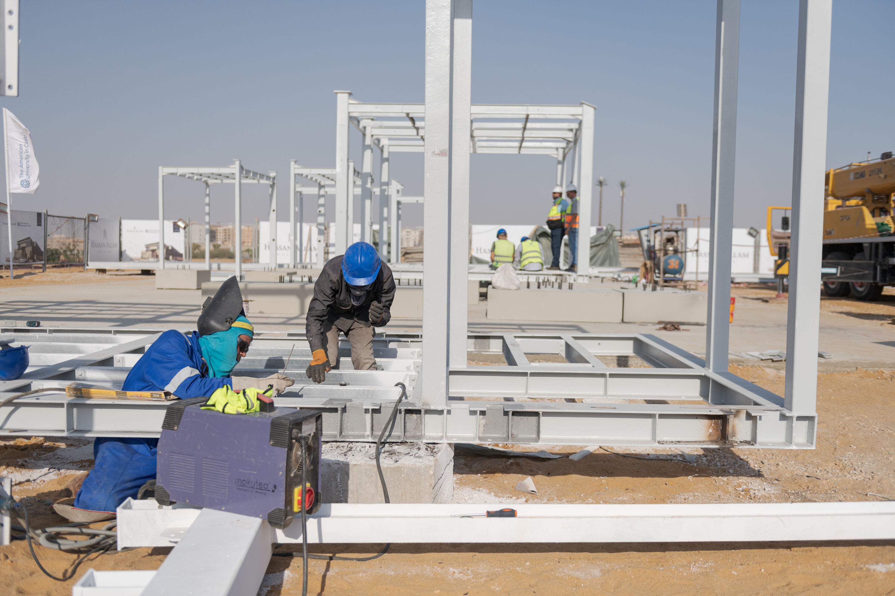 Dual Degree MPA program image of students working in construction site with wearing construction helmets