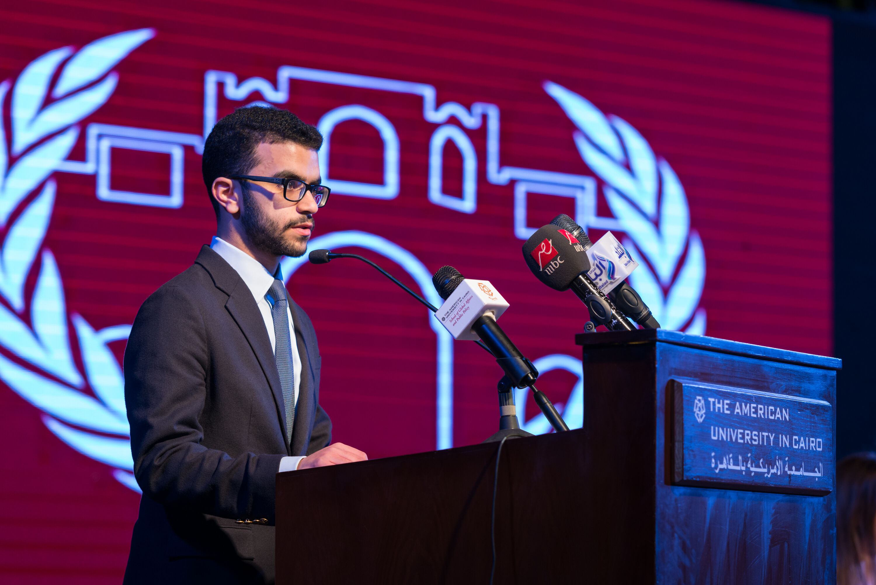 Dual Degree Political Science and International Human Law image of student giving a speech on a podium in a political conference