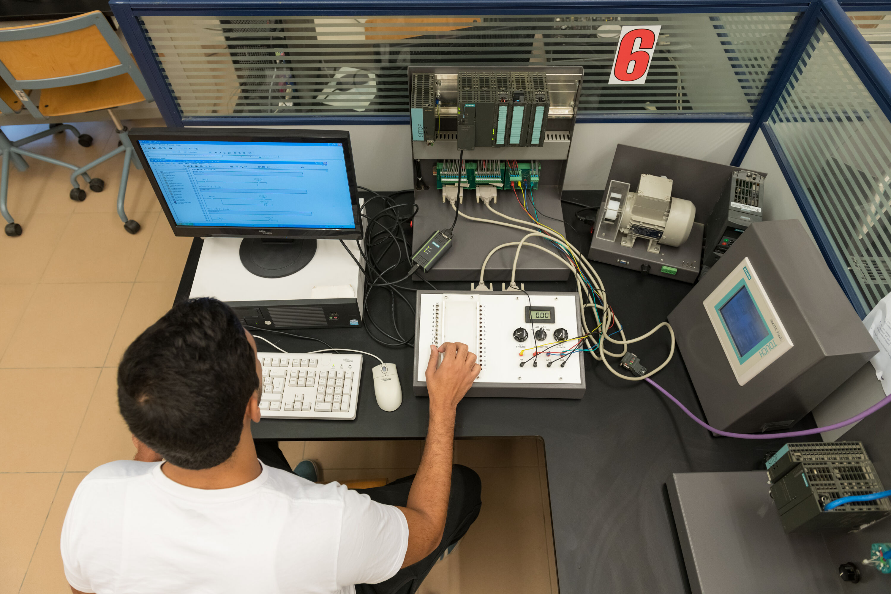 electronics and communications program image of student working on electronic equipment in lab