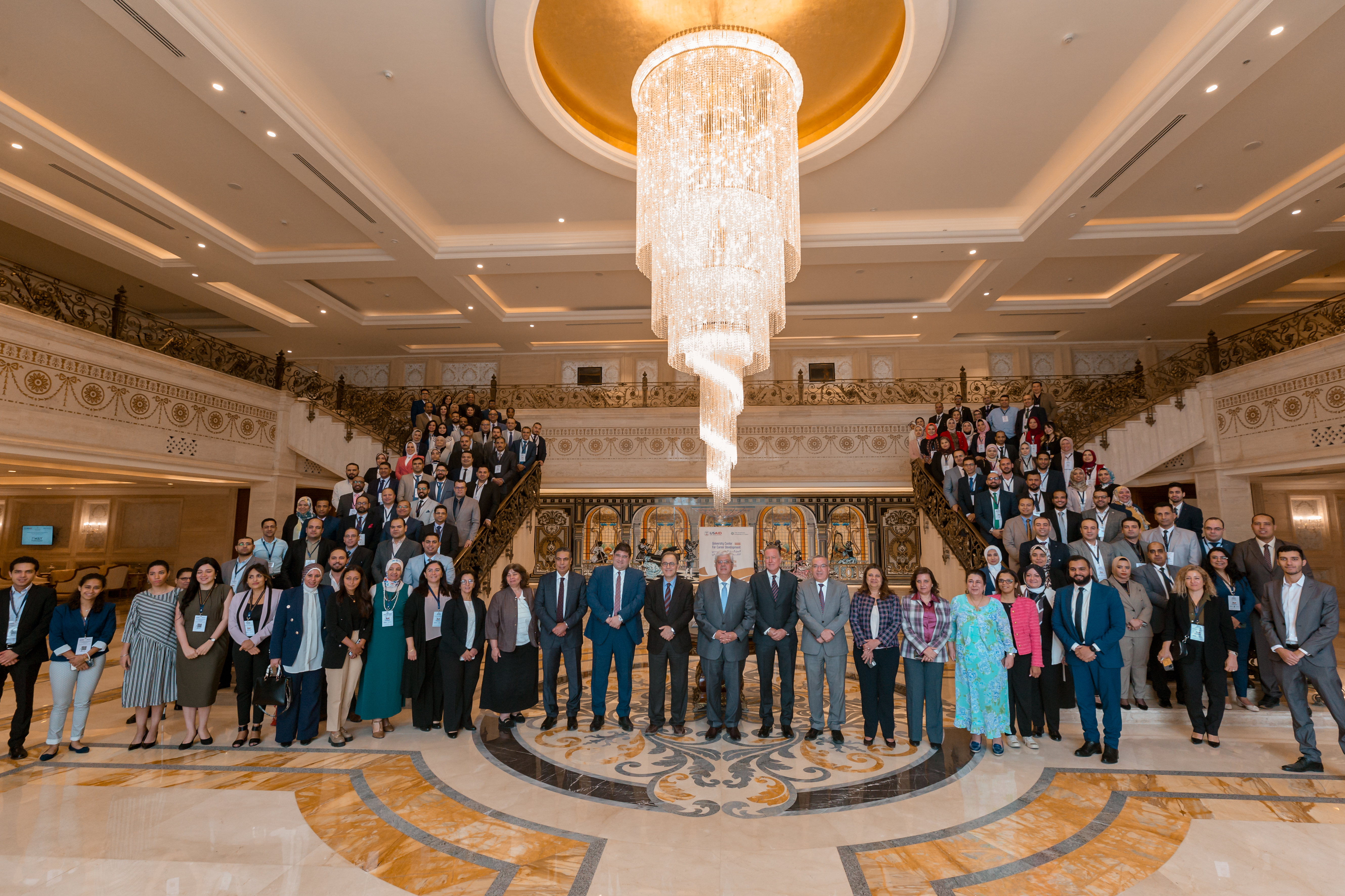 Large group of people standing in a group picture on stairs