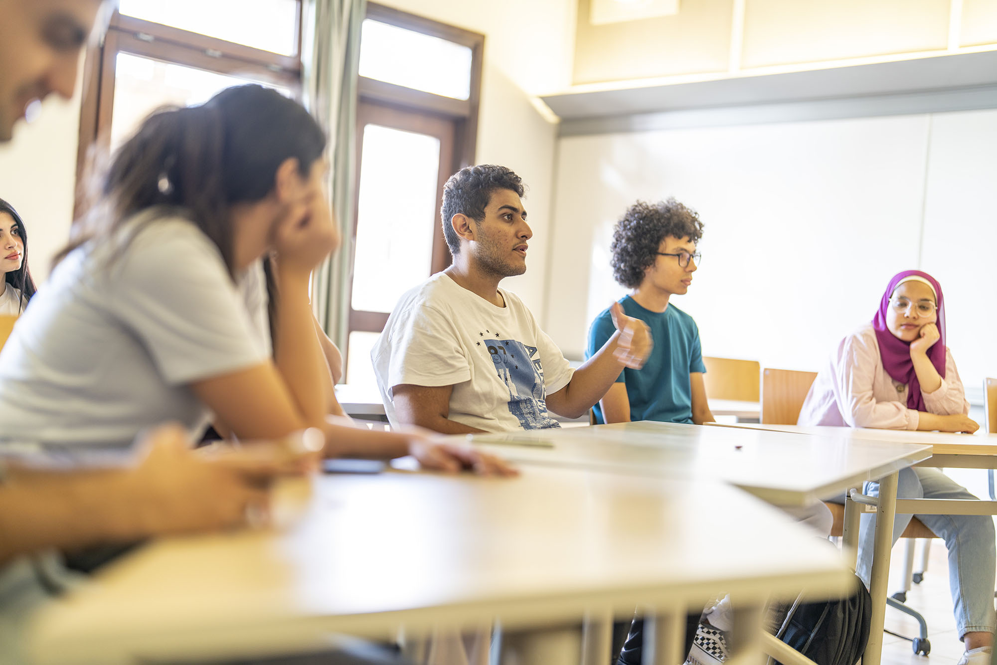 Migration and refugee program students discussing topics in class