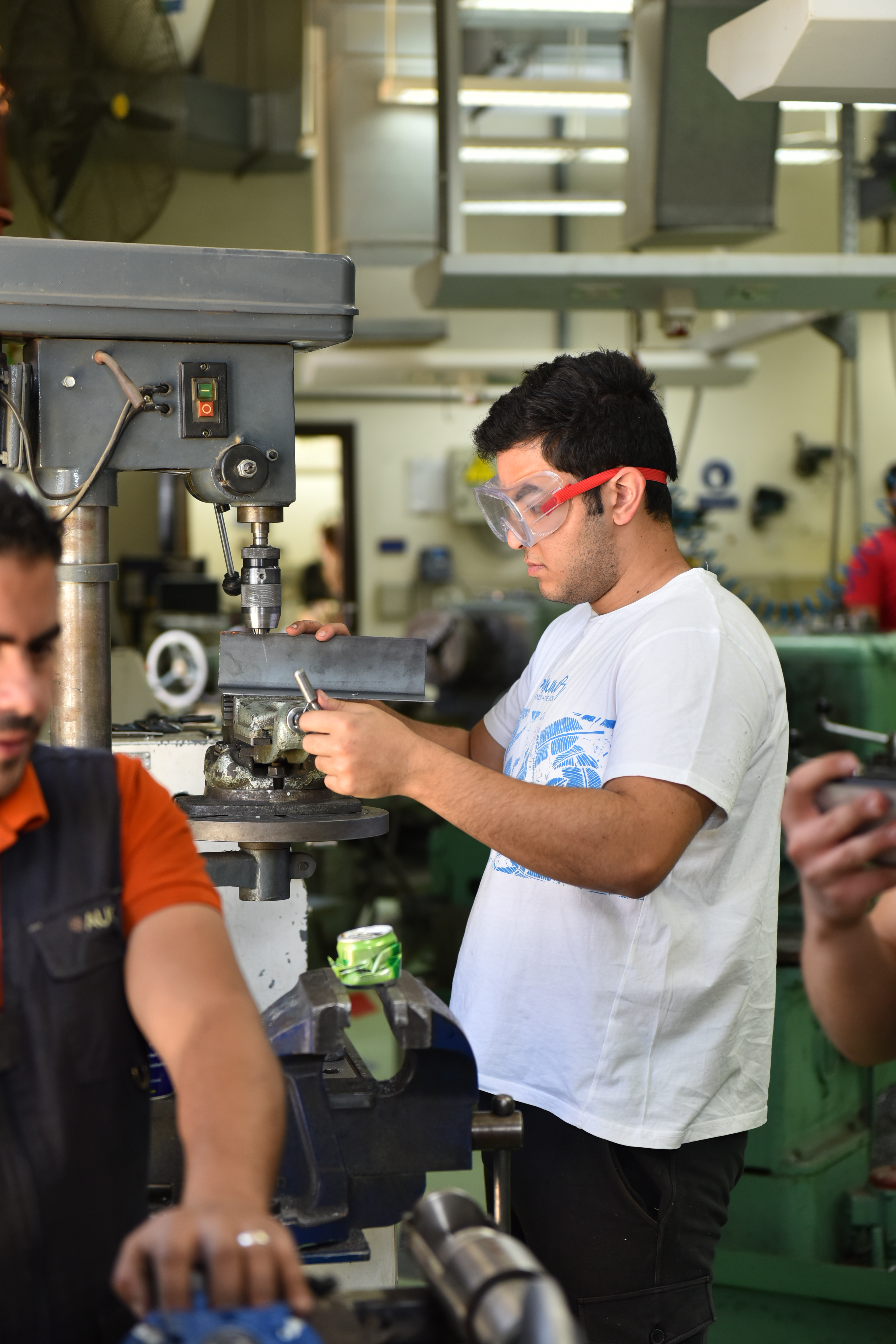petroleum engineering program student working with machinery in science lab