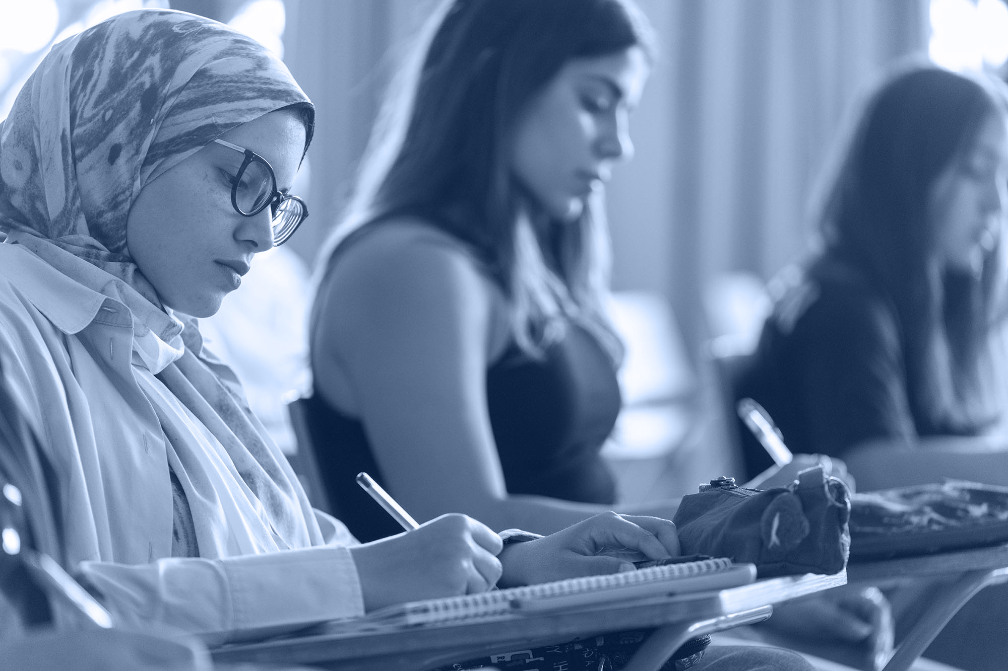 political science diploma montone image of female students in classroom taking notes