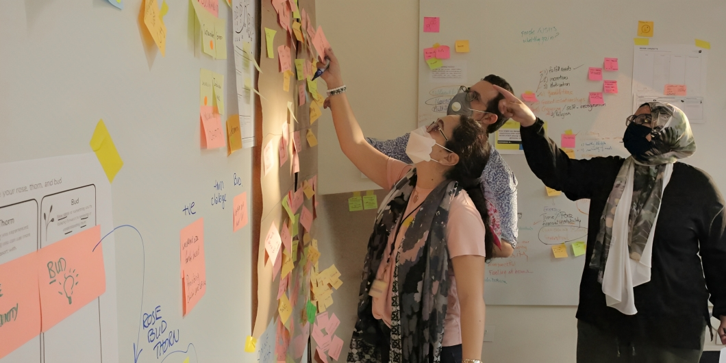 Girls pointing on a white board