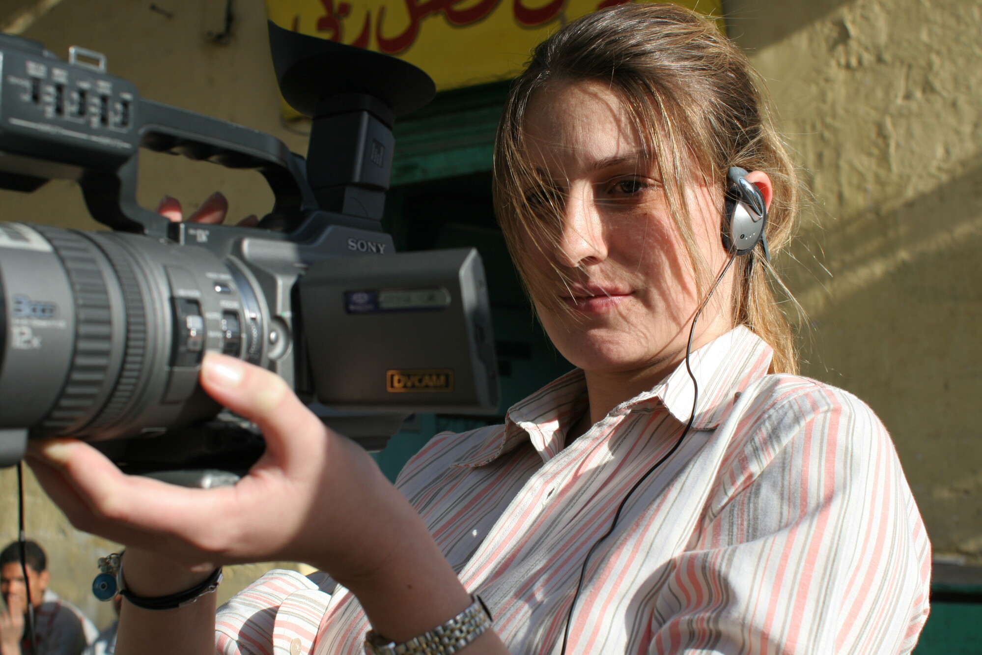 female student with camera shooting film
