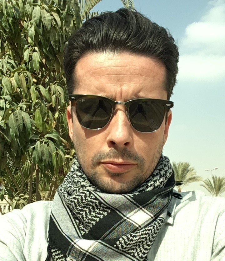 Man wearing sunglasses and a scarf