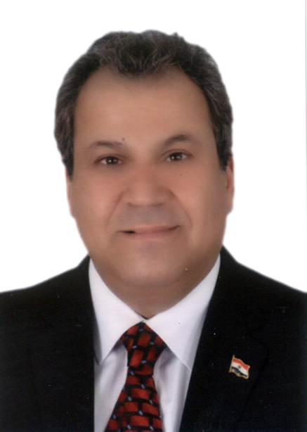 Headshot of a man wearing a suit and tie