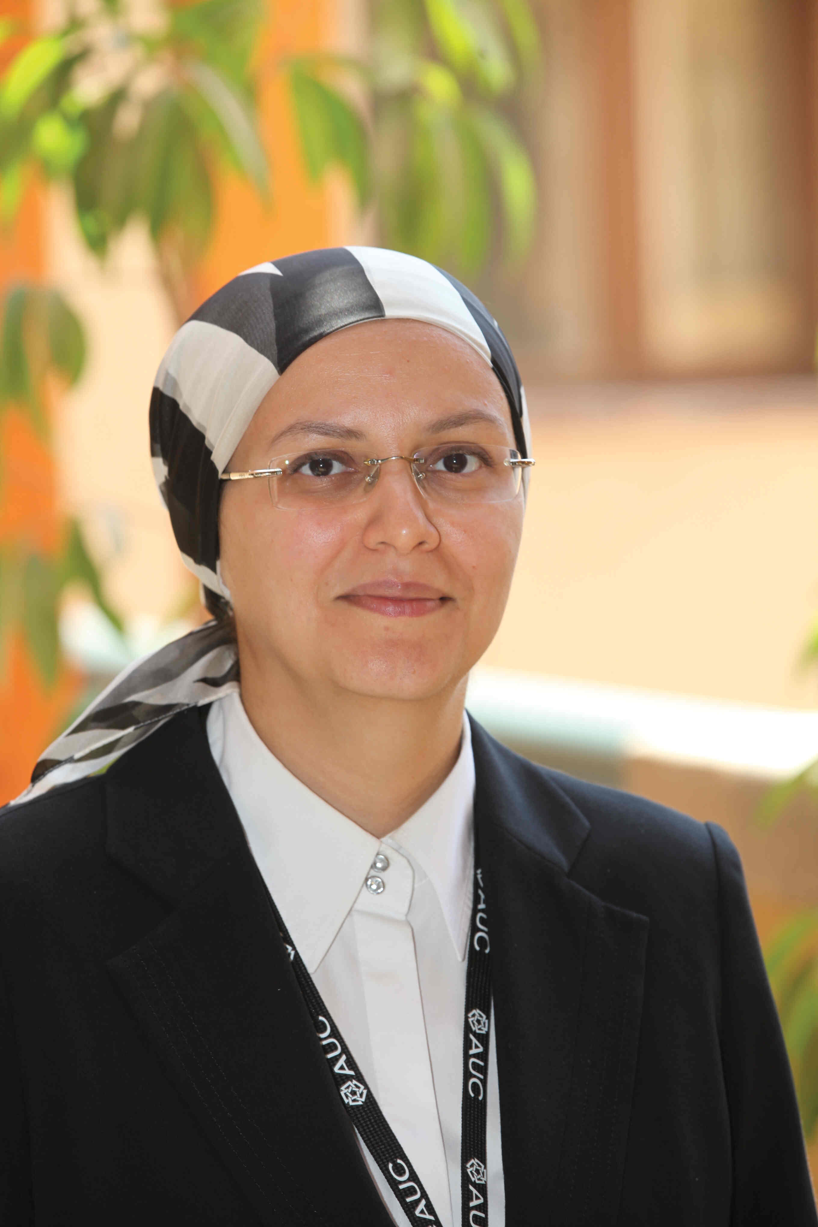 A headshot of a veiled women smiling