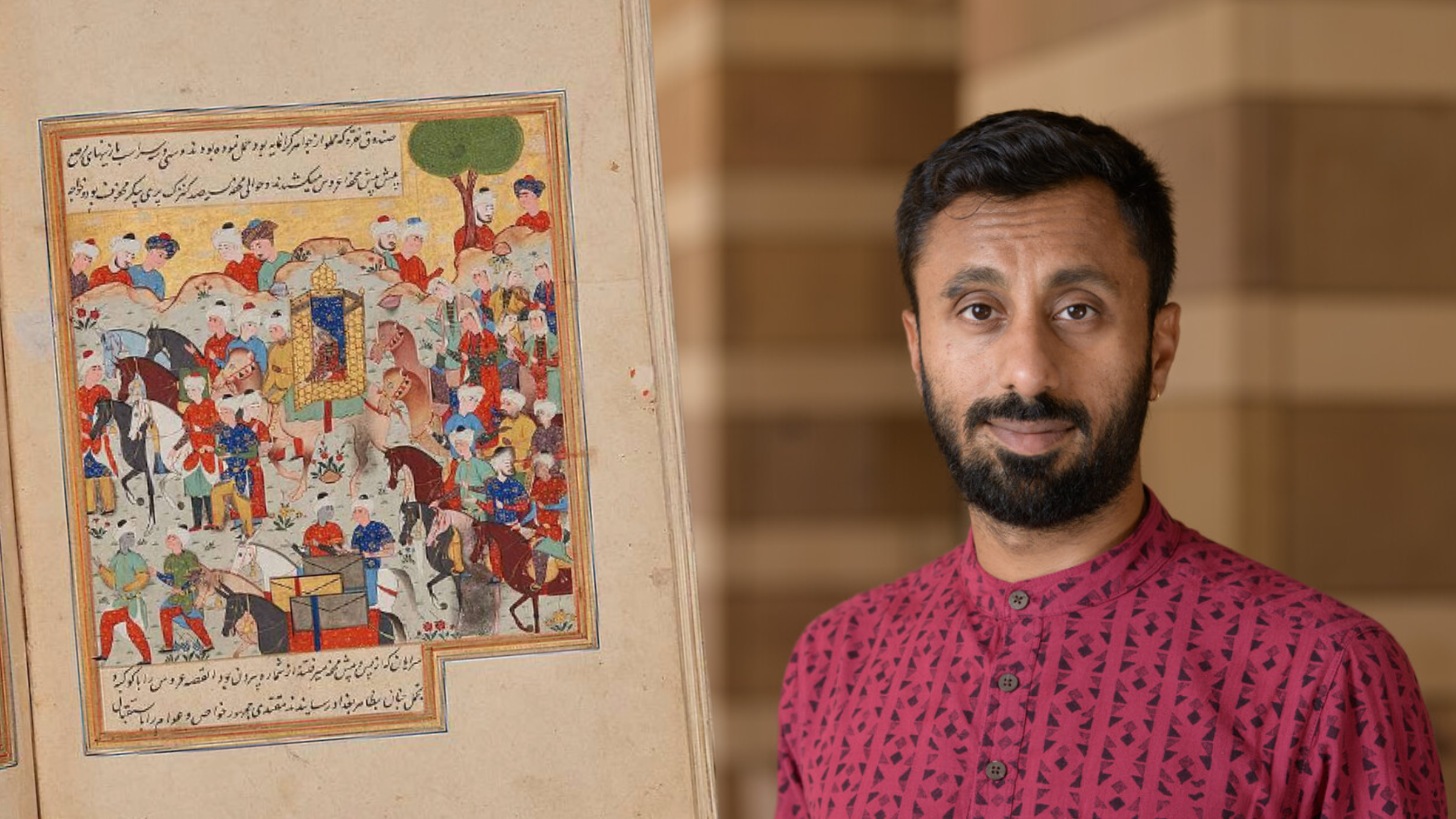 Man in red shirt stands next to a brightly colored illustration on a time-worn page