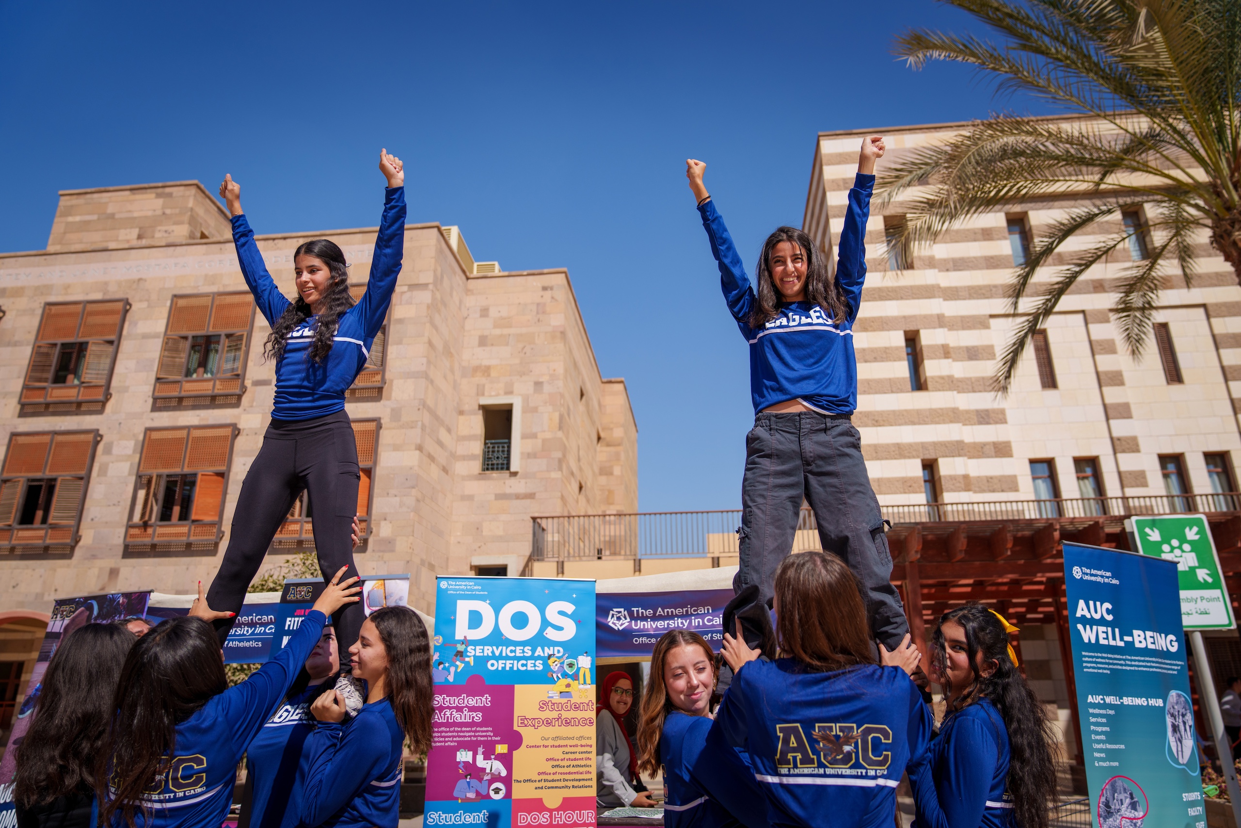 Two AUC girl students cheering in a student event 