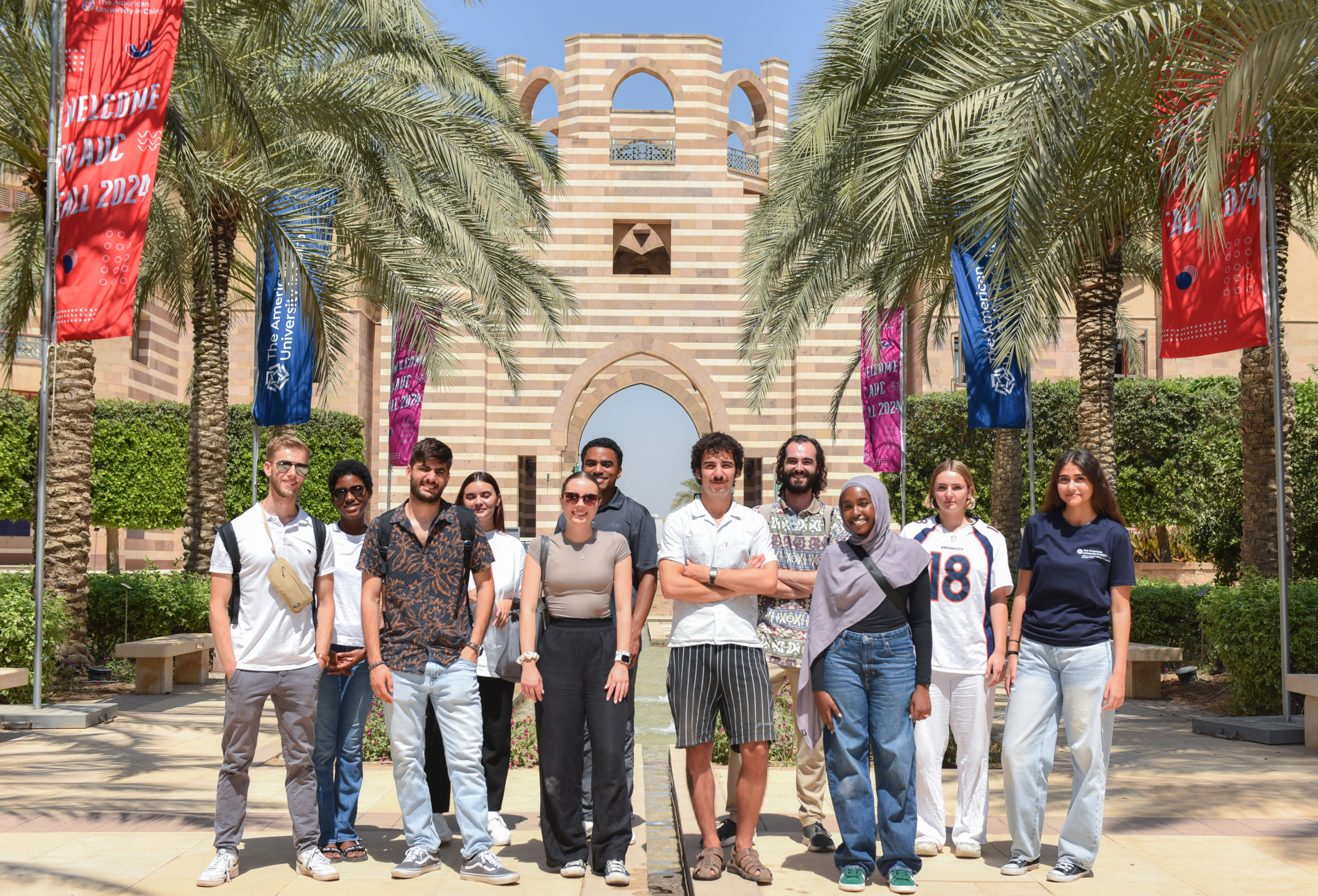 a group of international students taking a group photo at AUC Portal