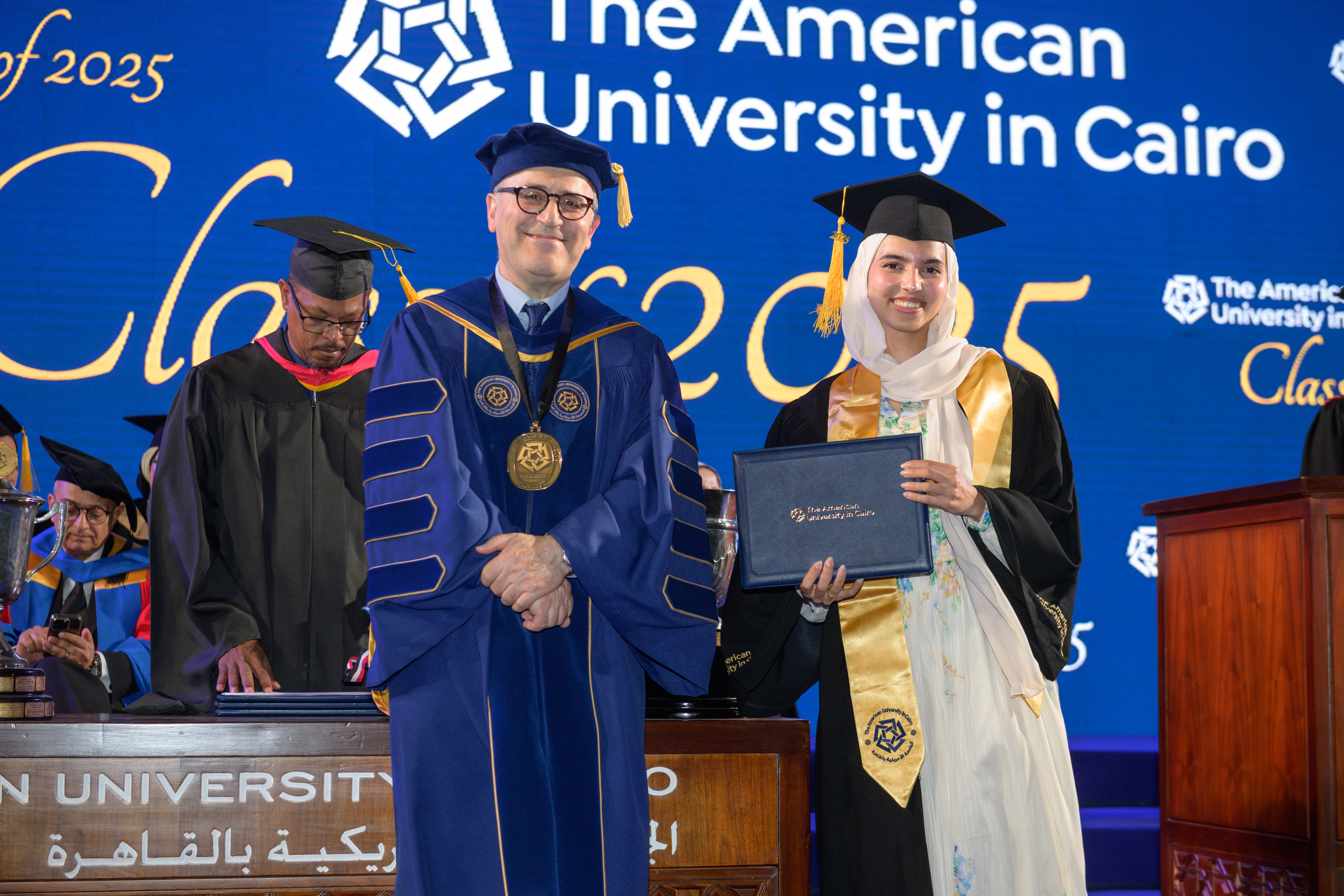 Female graduating senior with the President of the University