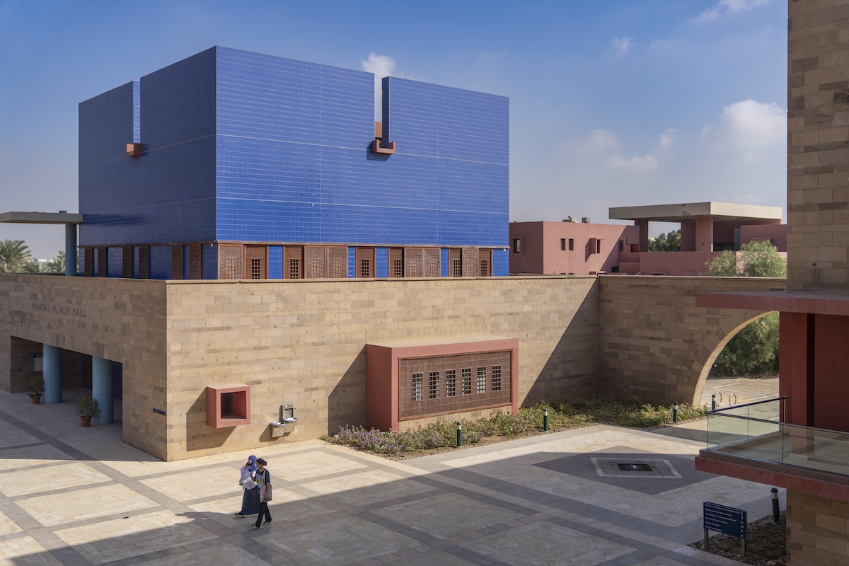 Moataz Al Alfi Hall at AUC with its distinctive blue exterior panels overlooking a campus courtyard.