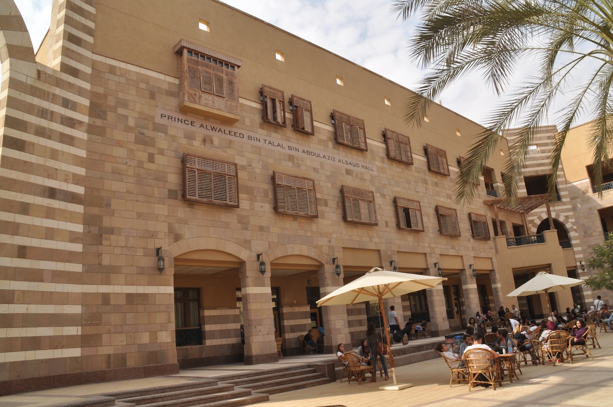 Prince Alwaleed Bin Talal Bin Abdulaziz Al Saud building with students seated in the outdoor courtyard.