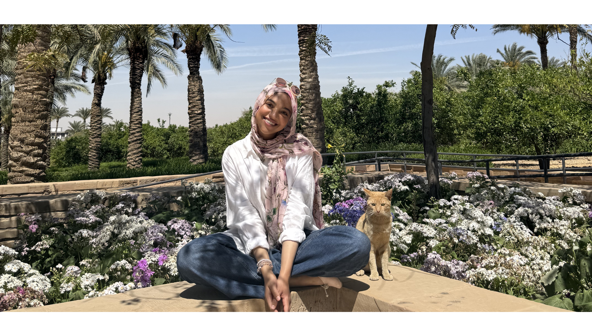 Laila sitting in the AUC gardens with a cat