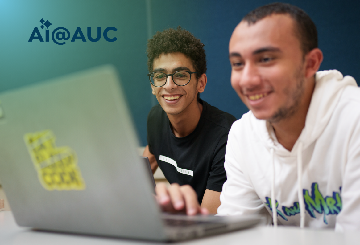 two students looking at a laptop and on the upper left the logo: AI@AUC