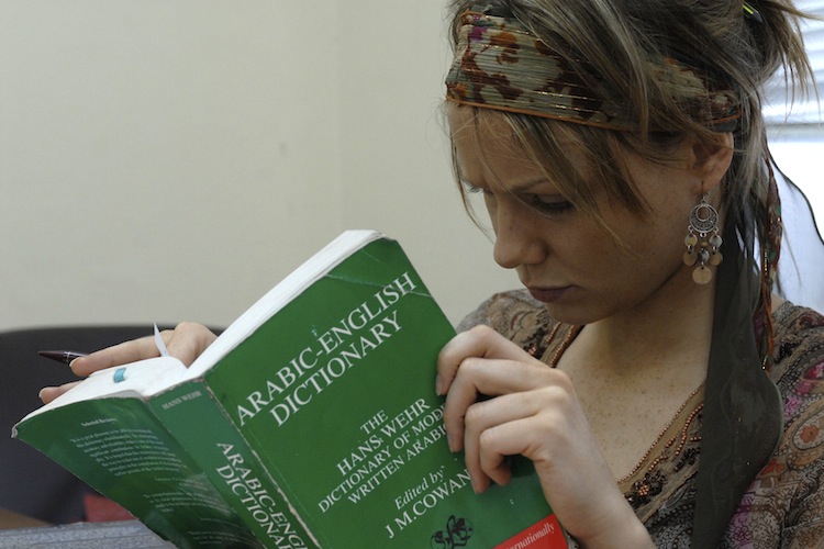 AUC student reading a book