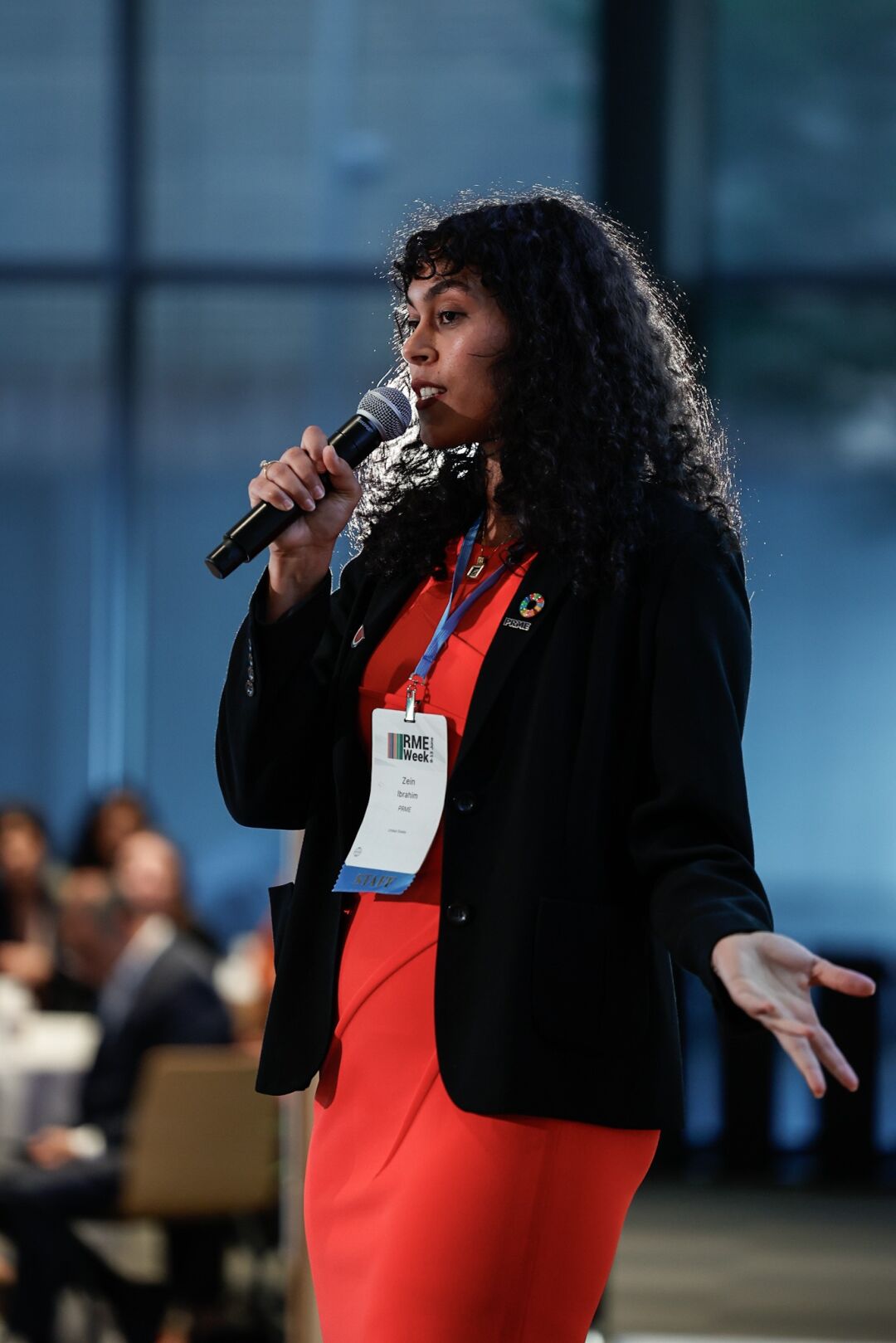 Zein Ibrahim stands and talks into a microphone