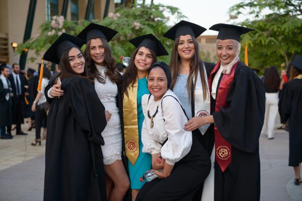Graduating girls wearing cap and gown