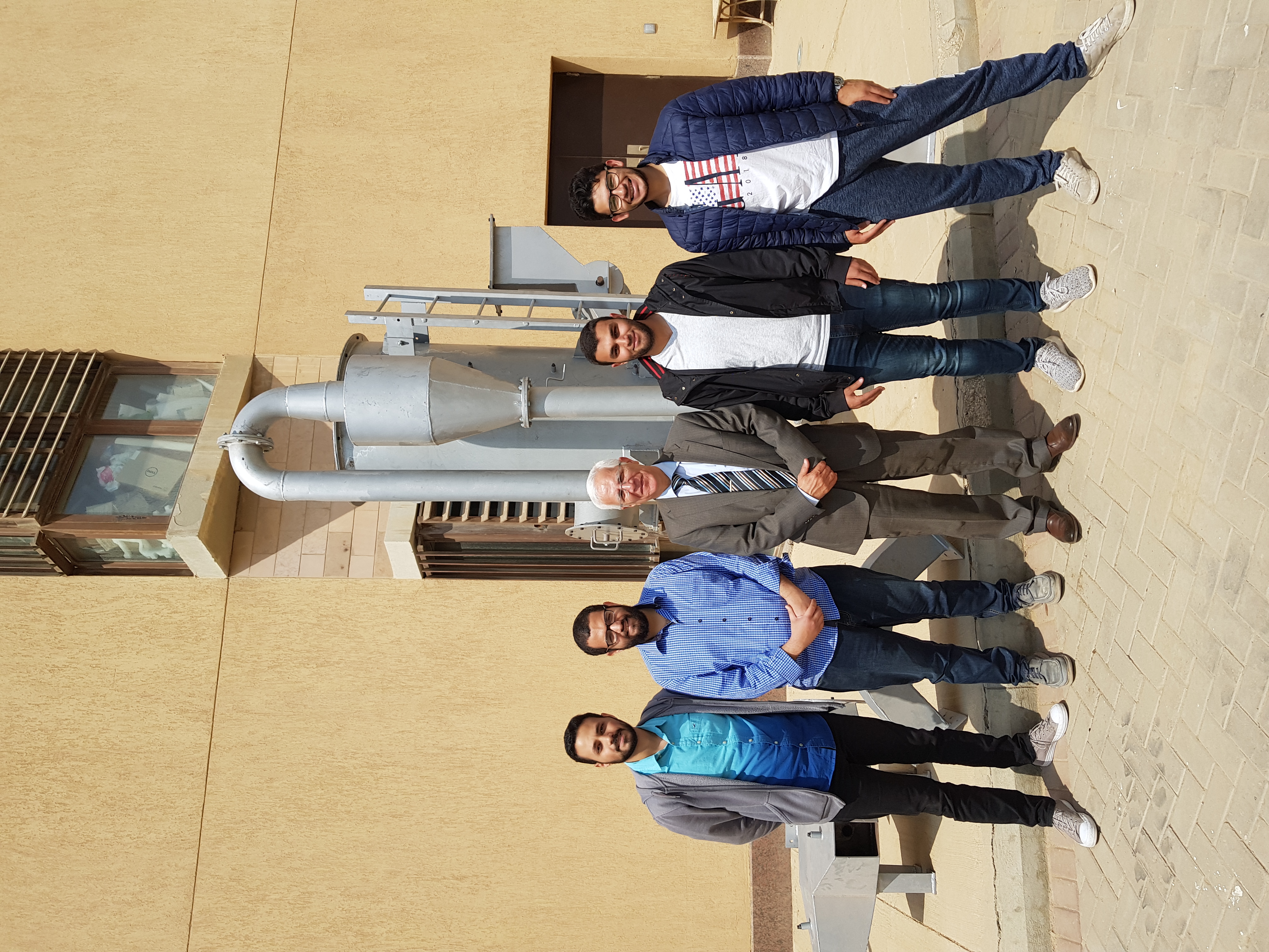 Mohy Mansour, adjunct professor of mechanical engineering, with students on campus