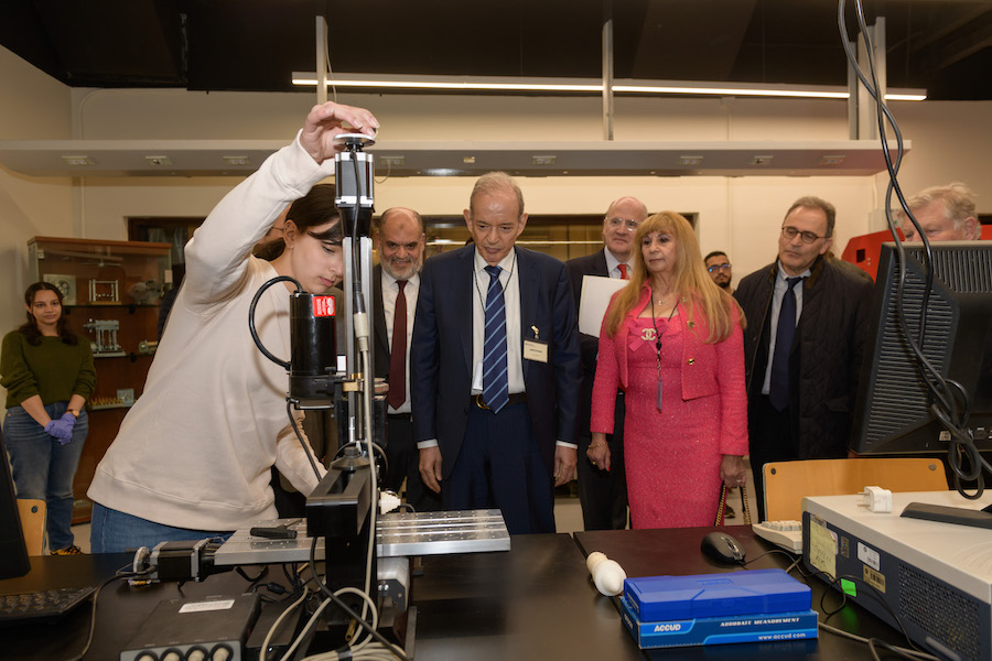 AUC Trustee Dr. Atef Eltoukhy watching a demonstration by a student at the learning factory