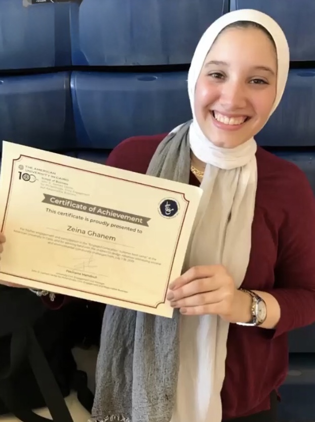 Zeina Ghanem holds a certificate of achievement awarded by AUC