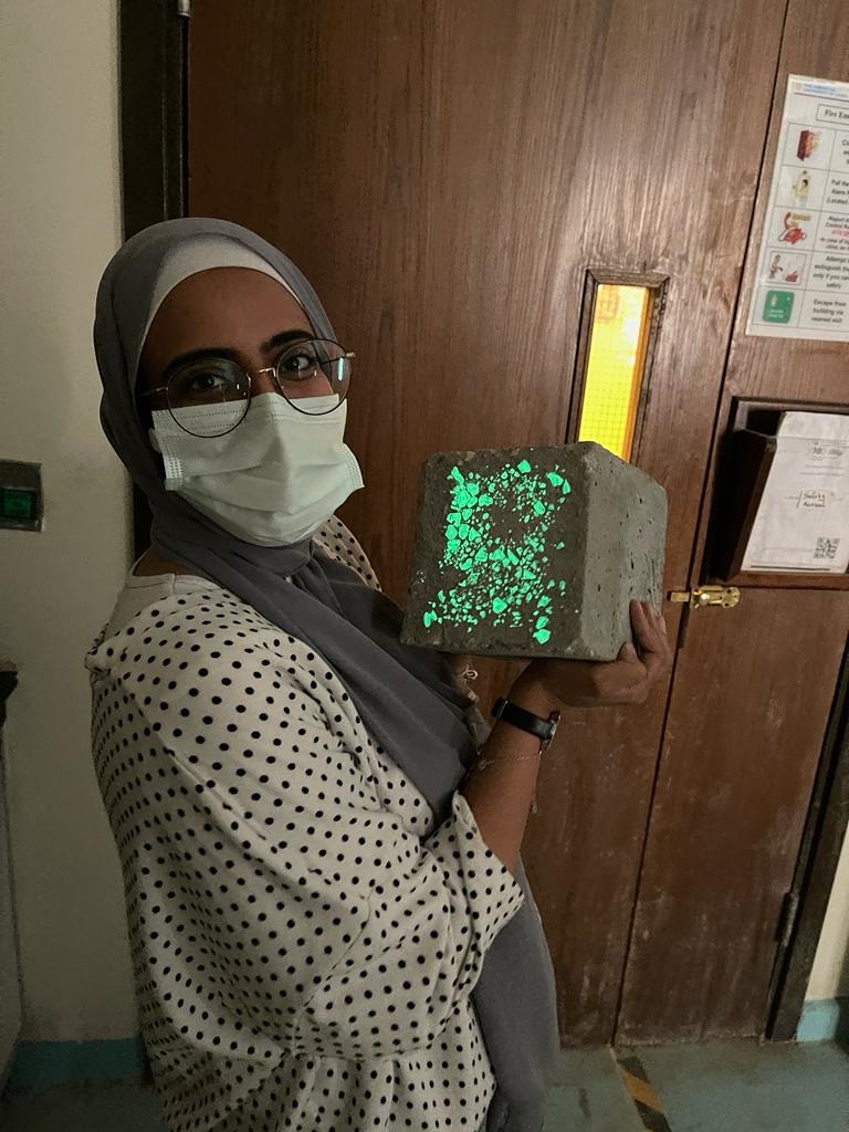 AUC student holds self-luminous concrete