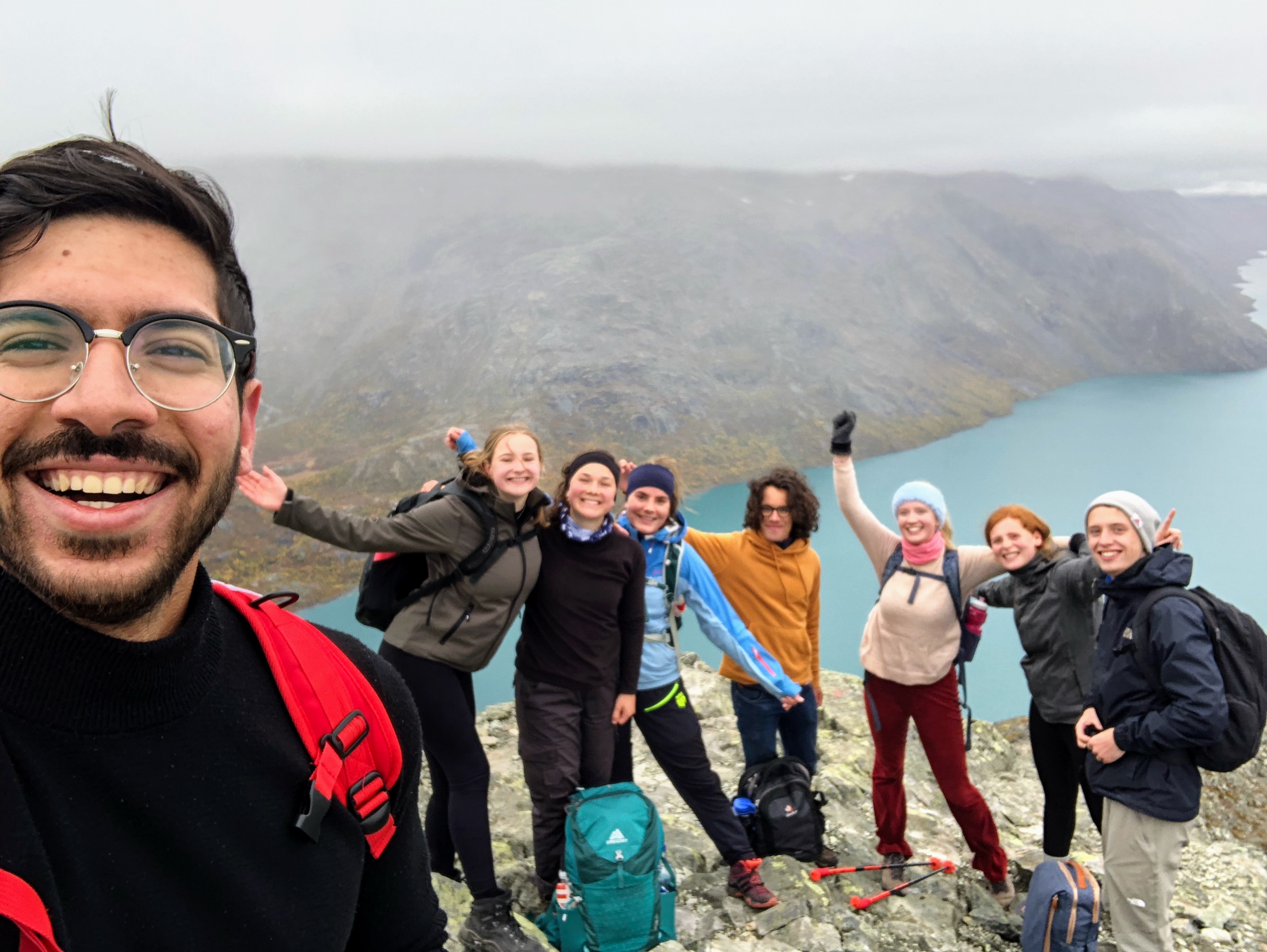 Abdalla Ashraf takes a selfie with his friends on a cliff in Norway over a body of water