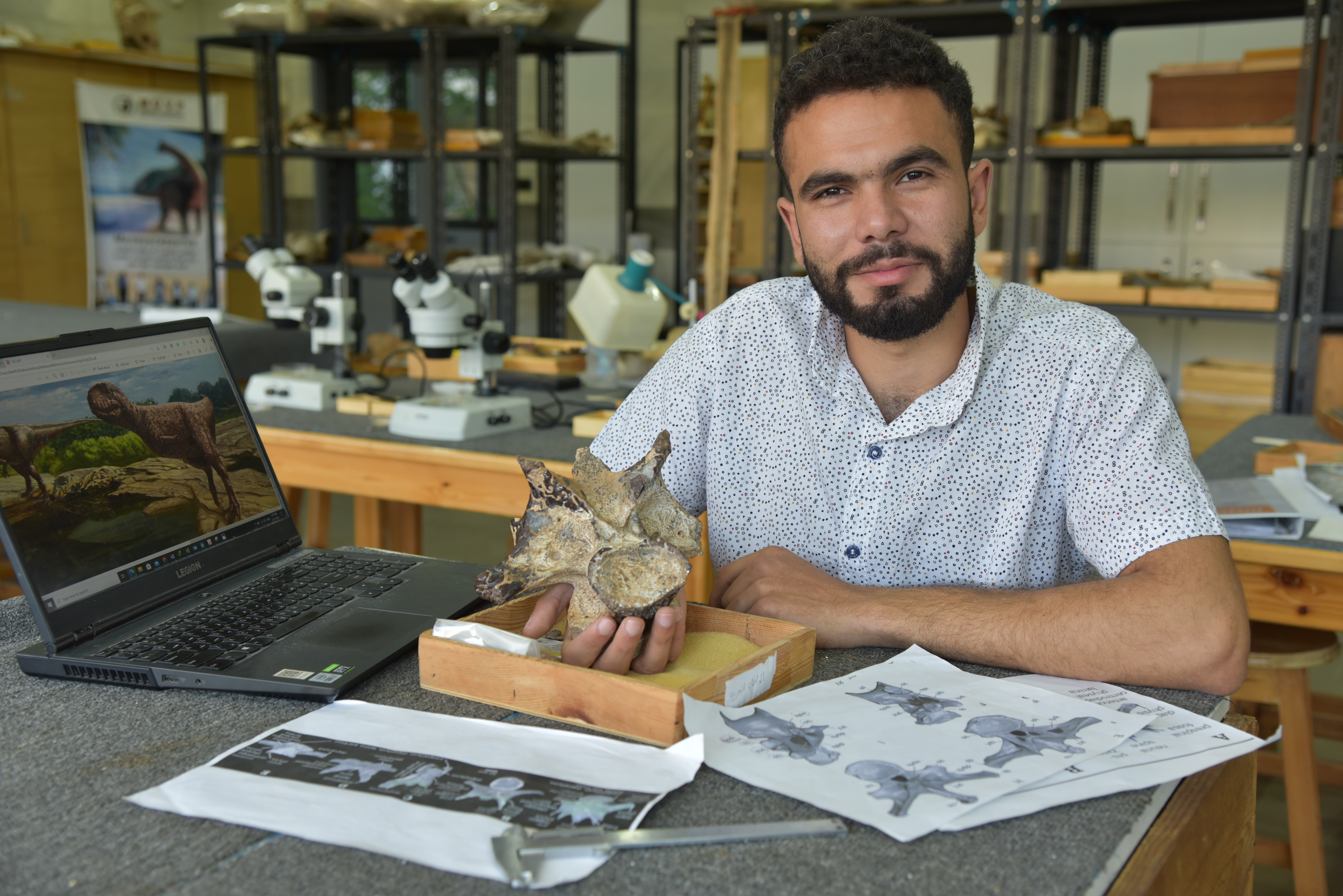 Belal Salem with abelisaurid vertabra