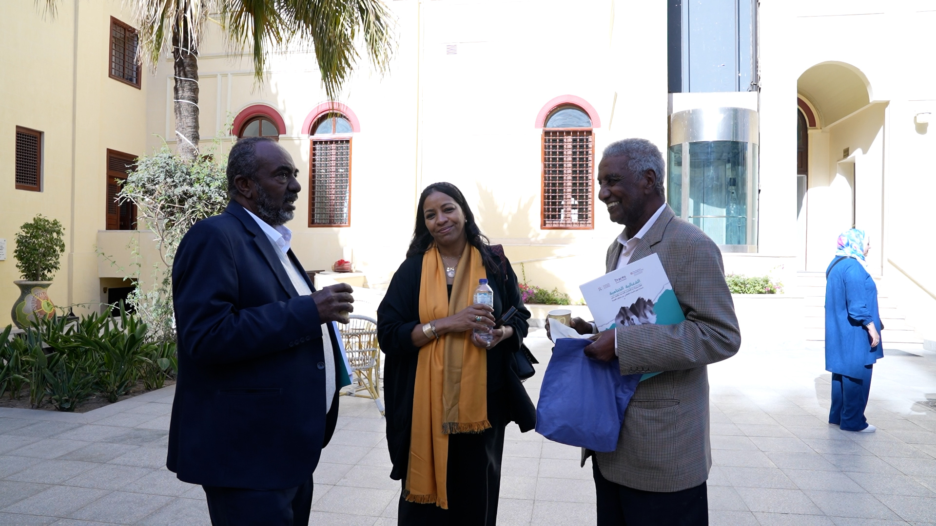 Amira talks with colleagues at conference