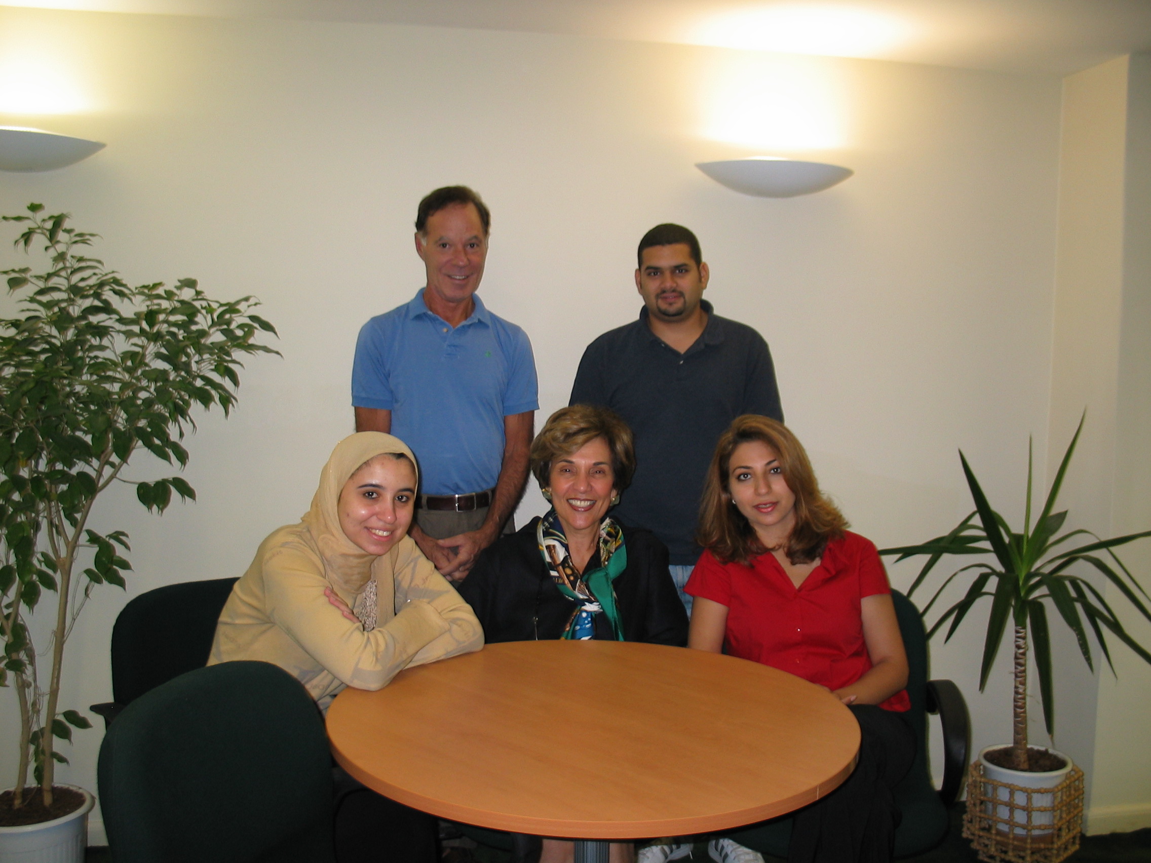 Group of people gathered around a round table