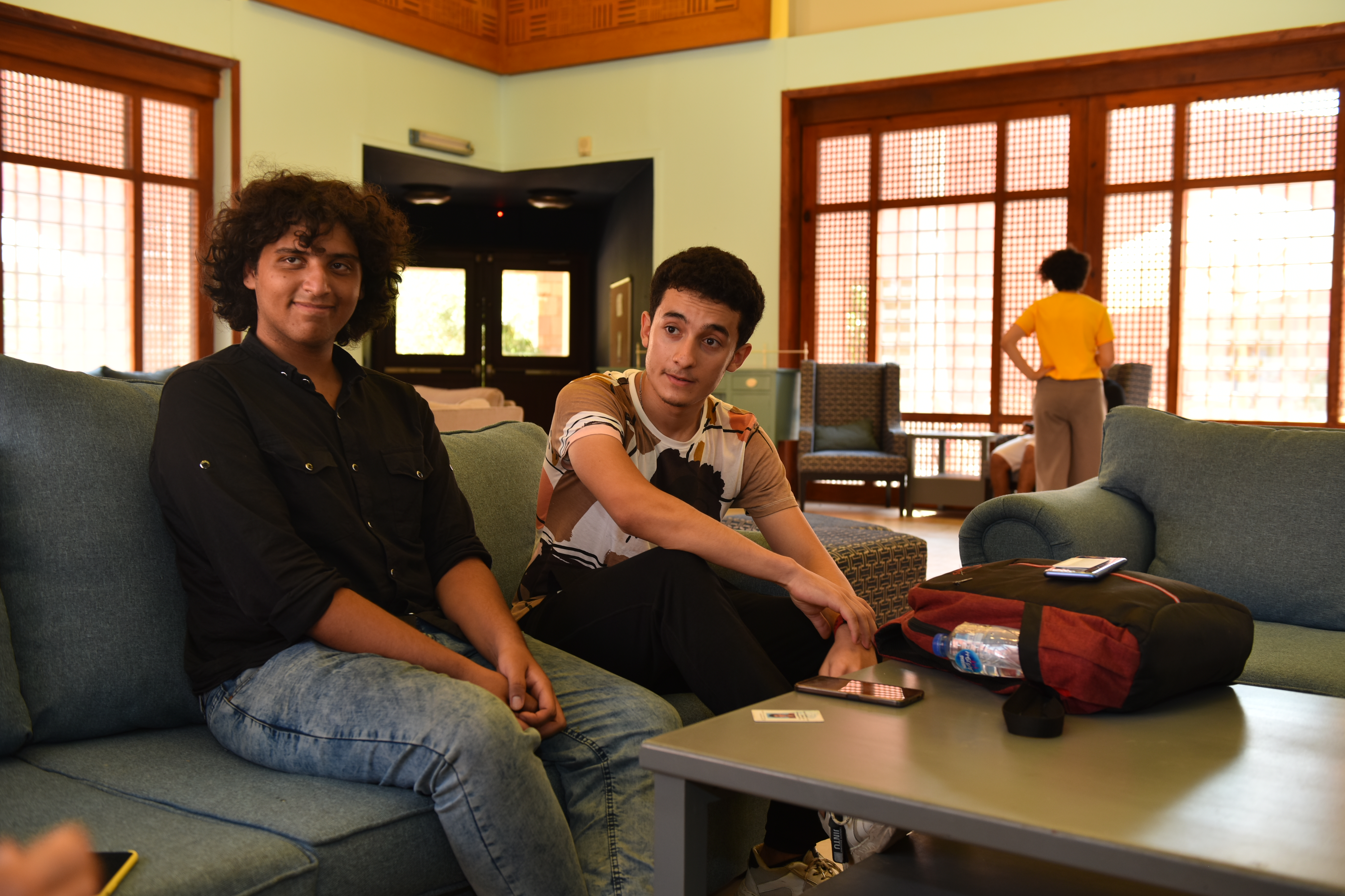 Badr and Rehab sit in the common area at the University Residences